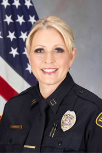 "Assistant Chief Diana Duffy in TPD uniform next to American flag"