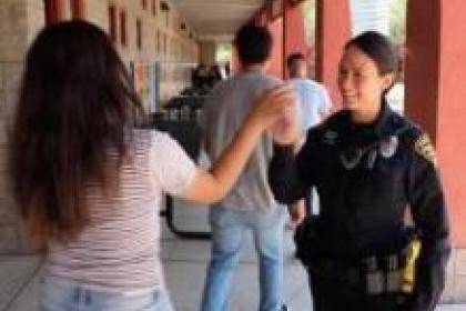 Highschool outreach student and officer high five