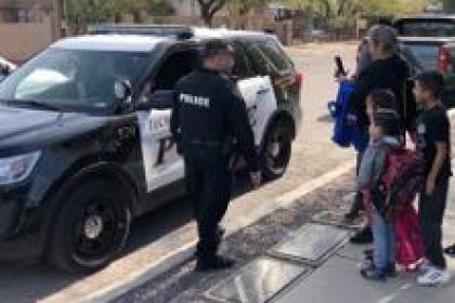 Officer assisting students on roadside